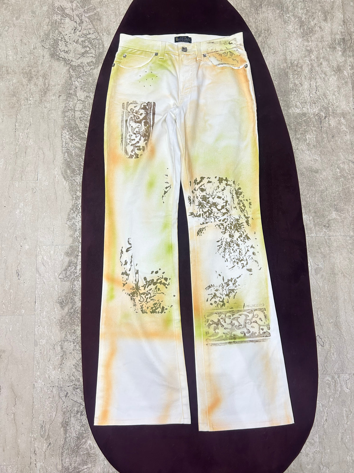 The Botanical Haze Vintage Jeans – white straight-leg jeans with olive and bronze print flat lay