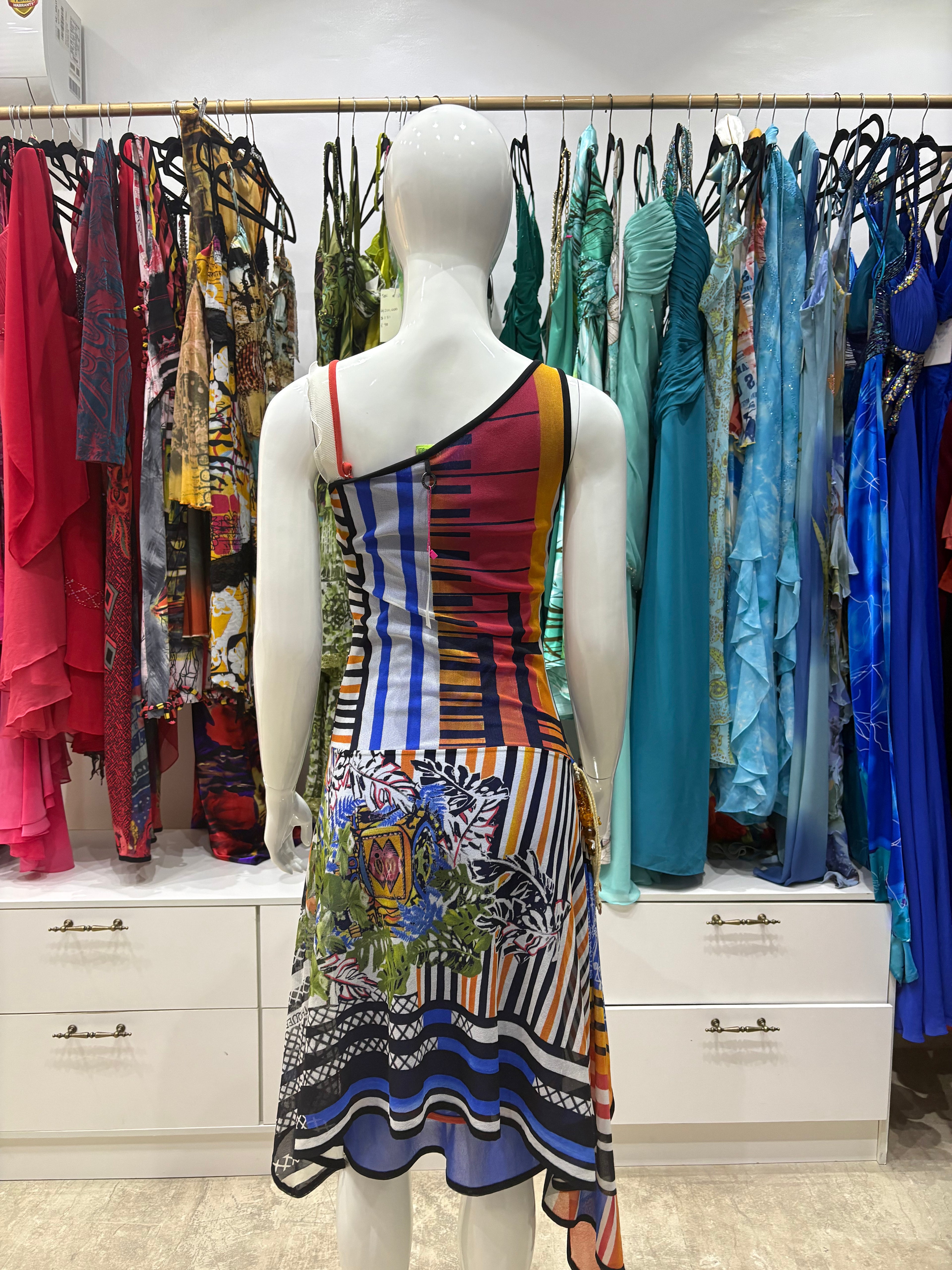 Blue Save The Queen Dress - A sleeveless, asymmetrical Save The Queen dress featuring a colorful, busy patchwork print with blue, purple, orange, and black patterns.